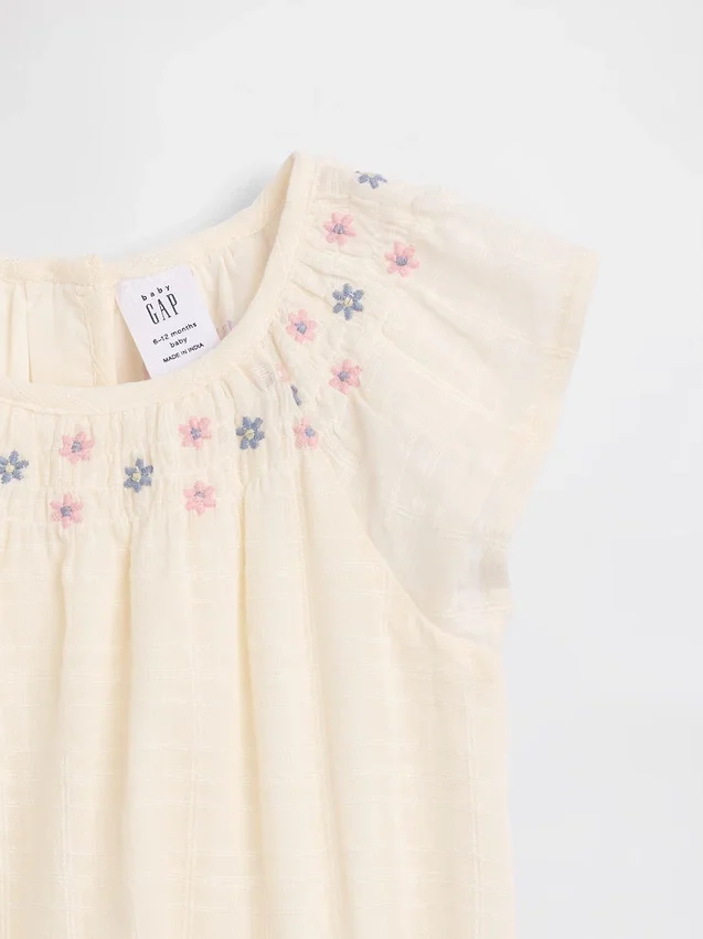 Baby-body met gesmokt bloemenpatroon