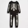 Biologische pyjamaset van geborsteld katoen voor kinderen en baby’s met in het donker oplichtend skeletmotief