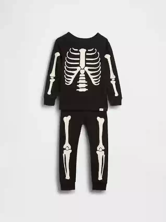Biologische pyjamaset van geborsteld katoen voor kinderen en baby’s met in het donker oplichtend skeletmotief