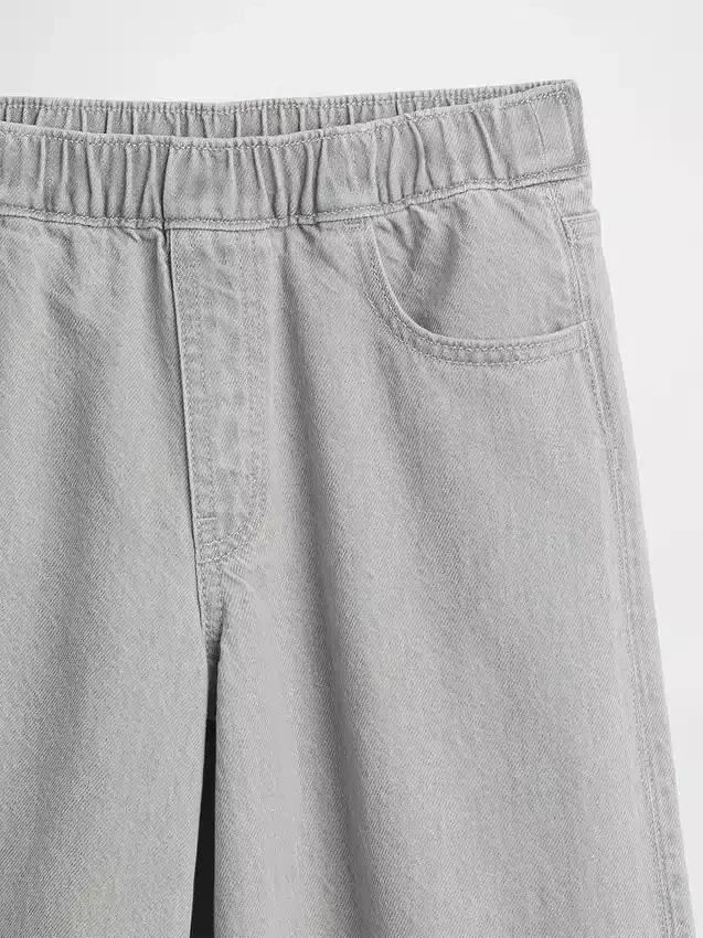 Kinderbaggy-Jeans met lage taille, strik en gespleten zoom