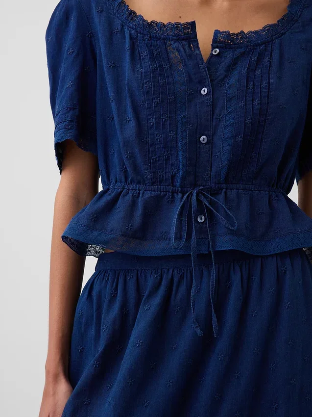 Top met peplum en kanten rand
